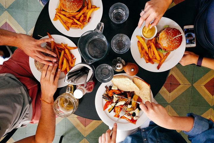 Friends eating burgers and fries together